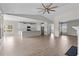 Open-concept living room with a kitchen island, stainless steel appliances, and wood-look flooring at 5501 Bristle Cone Ct., Myrtle Beach, SC 29577