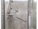 Modern tiled shower featuring a rainfall showerhead, handheld sprayer, and convenient grab bar for accessibility at 5501 Bristle Cone Ct., Myrtle Beach, SC 29577