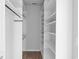 Spacious walk-in closet featuring custom white shelving, wooden floors, and ample storage space at 5501 Bristle Cone Ct., Myrtle Beach, SC 29577