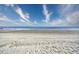 Vast beach with soft sand and calm ocean waters under a bright, partially cloudy sky at 5523 N Ocean Blvd. # 1513, Myrtle Beach, SC 29577