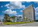 High-rise condo building with lush landscaping and signage in front of the property at 5523 N Ocean Blvd. # 1513, Myrtle Beach, SC 29577