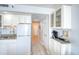 Compact kitchen with white appliances and cabinets, plus granite countertops at 5523 N Ocean Blvd. # 1513, Myrtle Beach, SC 29577