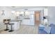 Cozy kitchen with white cabinets, granite countertops, and an adjacent breakfast bar at 5523 N Ocean Blvd. # 1513, Myrtle Beach, SC 29577