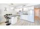 Efficient kitchen with white cabinetry, granite countertops, breakfast bar, and modern appliances at 5523 N Ocean Blvd. # 1513, Myrtle Beach, SC 29577
