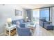 Comfortable living room with blue furniture, stylish decor, and a sliding glass door to a great view at 5523 N Ocean Blvd. # 1513, Myrtle Beach, SC 29577