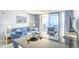 Comfortable living room with blue furnishings, a balcony, and beautiful ocean views at 5523 N Ocean Blvd. # 1513, Myrtle Beach, SC 29577