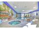 Indoor pool and hot tub with lounge seating and a mural on the wall providing an inviting recreation space at 5523 N Ocean Blvd. # 1513, Myrtle Beach, SC 29577
