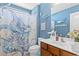 Bathroom featuring wooden vanity, blue walls, marine decor, and octopus shower curtain at 556 Cedar Lakes Dr., Little River, SC 29566
