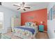 Bedroom featuring a queen bed, orange accent wall, ceiling fan and decor at 556 Cedar Lakes Dr., Little River, SC 29566
