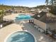 View of community pools and clubhouse with palm trees and ample seating at 556 Cedar Lakes Dr., Little River, SC 29566
