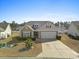 Charming single-story home with neutral siding, well-manicured lawn and a two-car garage at 556 Cedar Lakes Dr., Little River, SC 29566