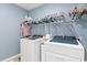 Clean laundry room with new washer and dryer units and ample storage space at 556 Cedar Lakes Dr., Little River, SC 29566
