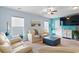 Inviting living room with modern ceiling fan, beach decor, and neutral colored furniture at 556 Cedar Lakes Dr., Little River, SC 29566