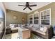 Comfortable screened in patio with a gas fire pit and ample seating at 556 Cedar Lakes Dr., Little River, SC 29566