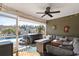 Cozy screened-in patio with comfortable seating, fire table, and a clear view of the pool and hot tub at 556 Cedar Lakes Dr., Little River, SC 29566