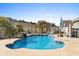 Backyard pool area with palm trees and a hot tub, perfect for relaxing and entertaining at 556 Cedar Lakes Dr., Little River, SC 29566