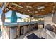 Outdoor kitchen and bar area with corrugated metal, wooden accents and a variety of appliances and storage at 556 Cedar Lakes Dr., Little River, SC 29566