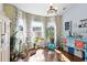 Sun room with hardwood floors, bay windows, and brightly colored curtains, decor and furniture at 556 Cedar Lakes Dr., Little River, SC 29566