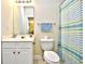 Clean bathroom includes a vanity, toilet, and shower with a striped curtain at 5801 Oyster Catcher Dr. # 723, North Myrtle Beach, SC 29582