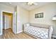 Neutral bedroom features a daybed with a quilt and a sailboat painting at 5801 Oyster Catcher Dr. # 723, North Myrtle Beach, SC 29582