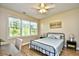 Comfortable bedroom with a ceiling fan, large window, and a peaceful ambiance for restful nights at 5801 Oyster Catcher Dr. # 723, North Myrtle Beach, SC 29582