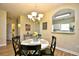 Cozy dining area featuring a stylish chandelier and a charming pass-through window to the bright kitchen at 5801 Oyster Catcher Dr. # 723, North Myrtle Beach, SC 29582
