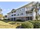 Multi-story condo building with brick facade, balconies, and manicured lawn at 5801 Oyster Catcher Dr. # 723, North Myrtle Beach, SC 29582