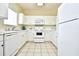 Bright kitchen featuring white appliances, ample cabinet space, and a functional layout for easy meal preparation at 5801 Oyster Catcher Dr. # 723, North Myrtle Beach, SC 29582