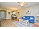 Open living area featuring wood floors, a comfortable couch, and a view into the kitchen at 5801 Oyster Catcher Dr. # 723, North Myrtle Beach, SC 29582