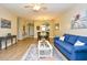 Spacious living room with light wood flooring, comfortable seating, and view into kitchen at 5801 Oyster Catcher Dr. # 723, North Myrtle Beach, SC 29582
