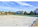 Sand volleyball court surrounded by green space and mature trees on a sunny day at 5801 Oyster Catcher Dr. # 723, North Myrtle Beach, SC 29582