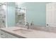 Bathroom vanity with a gray marble countertop, white cabinetry, and a mirror reflecting the glass shower at 598 Summer Green Ct., Sunset Beach, NC 28468