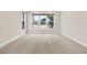 Neutral carpeted bedroom featuring a large window with natural light and views of the outdoors at 598 Summer Green Ct., Sunset Beach, NC 28468