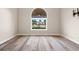 Empty bedroom featuring a large window with natural light and hardwood floors at 598 Summer Green Ct., Sunset Beach, NC 28468