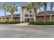 Exterior view of Sea Trail Villas Activity Center, featuring palm trees and ample parking at 598 Summer Green Ct., Sunset Beach, NC 28468