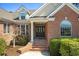 Charming brick home featuring a classic front door and well-maintained landscaping at 598 Summer Green Ct., Sunset Beach, NC 28468