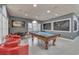 Well-lit game room with a pool table, seating area, and chalkboard accent walls at 598 Summer Green Ct., Sunset Beach, NC 28468