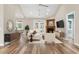 Open-concept living room with fireplace, hardwood floors and a vaulted ceiling at 598 Summer Green Ct., Sunset Beach, NC 28468