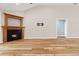 Living room with a fireplace, hardwood floors, and a view into another room at 598 Summer Green Ct., Sunset Beach, NC 28468
