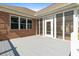 Covered brick patio with access to a screened-in porch, perfect for outdoor entertaining at 598 Summer Green Ct., Sunset Beach, NC 28468