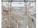 Close up of a glass enclosed marble shower with a built-in shelf at 598 Summer Green Ct., Sunset Beach, NC 28468