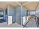 Spacious covered balcony with gray wood flooring and railing, complemented by durable siding at 6001-5126 S Kings Hwy., Myrtle Beach, SC 29575
