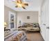 Bedroom featuring a futon, ceiling fan, and balcony access at 6001-5126 S Kings Hwy., Myrtle Beach, SC 29575