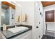Bathroom featuring a gray countertop, a white sink, and dark hardware and wooden ceiling at 604 Ocean Boulevard W, Holden Beach, NC 28462