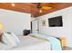 Bedroom features a ceiling fan, TV, and wood ceilings at 604 Ocean Boulevard W, Holden Beach, NC 28462