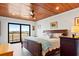 Comfortable bedroom with ceiling fan, wood ceiling, and a view of the water at 604 Ocean Boulevard W, Holden Beach, NC 28462