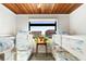 Spacious bedroom with wooden ceiling and bunk beds, showcasing the room's size and natural light at 604 Ocean Boulevard W, Holden Beach, NC 28462