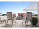 Relax on the deck with seating, bench and serene views of colorful houses at 604 Ocean Boulevard W, Holden Beach, NC 28462