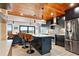 Modern kitchen featuring black cabinetry, stainless steel appliances, and barstool seating at the island at 604 Ocean Boulevard W, Holden Beach, NC 28462