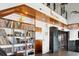 Open-concept living area with built-in bookshelves, wood ceilings, and a view to the upper floor at 604 Ocean Boulevard W, Holden Beach, NC 28462